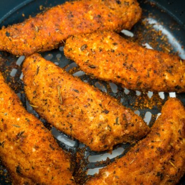 chicken tenders in the air fryer basket.