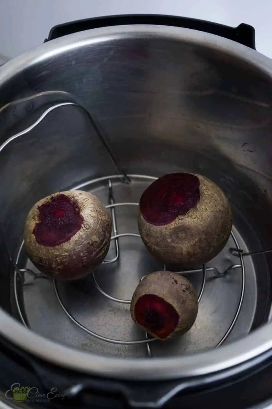 raw beets inside the pressure cooker with water before cooking.