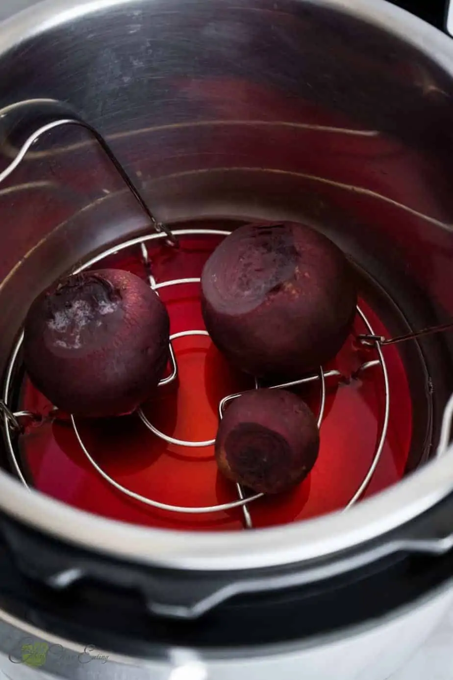 beets inside the instant pot after pressure cooking them, the water is stained with red color.