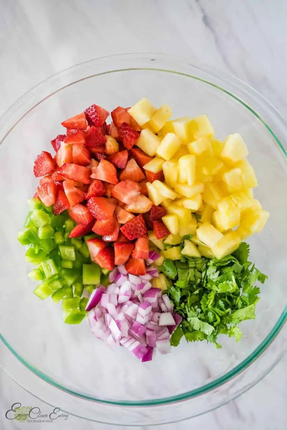 before mixing all the veggies and fruits of strawberry pineapple salsa