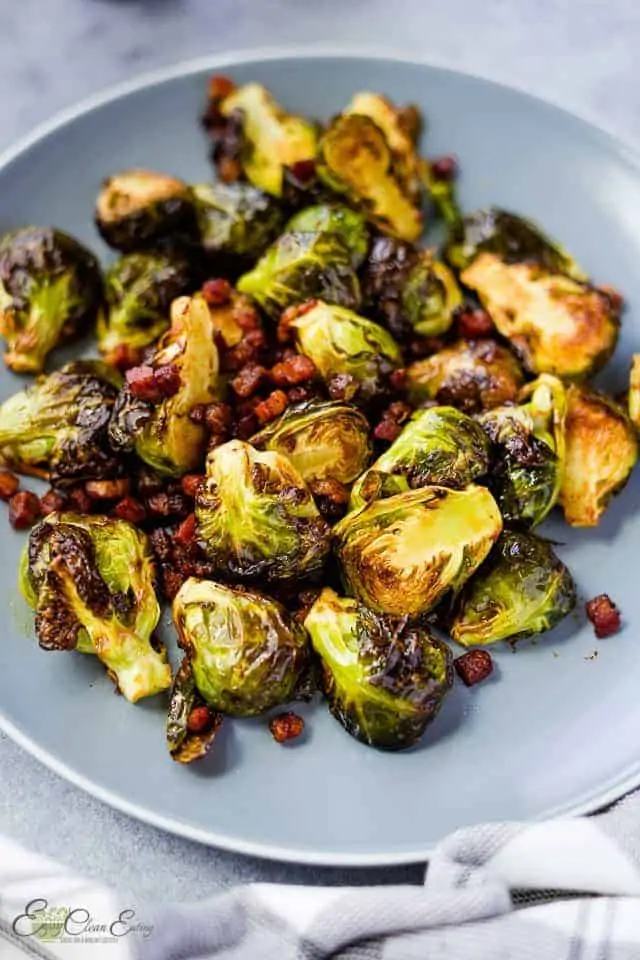air fried Brussels sprouts serve on a plate, napkin on the side