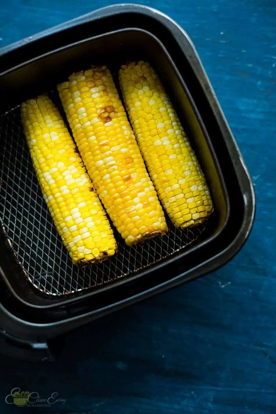 perfectly cooked corn on the corn inside the air fryer basket