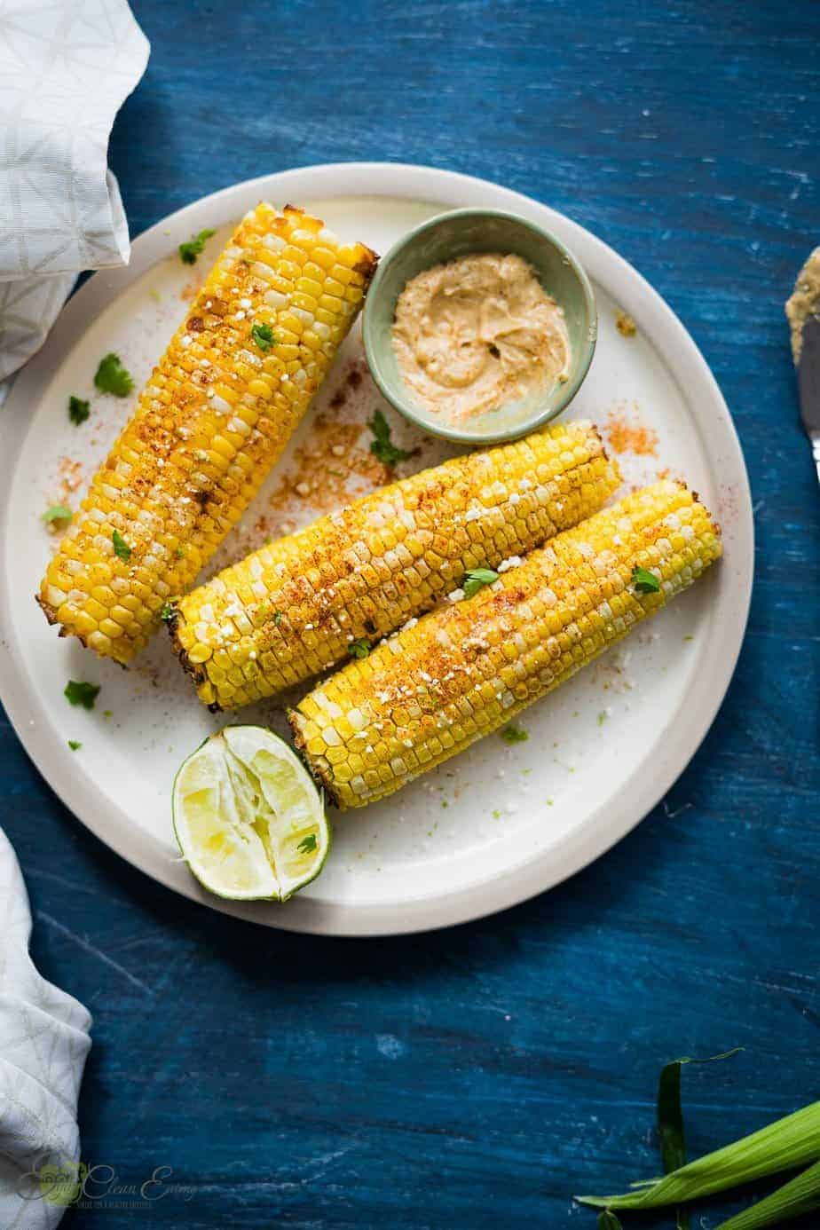 roasted corn on the cob served with chili lime butter, lime wedges, sprinkle with goat cheese, paprika and fresh cilantro.