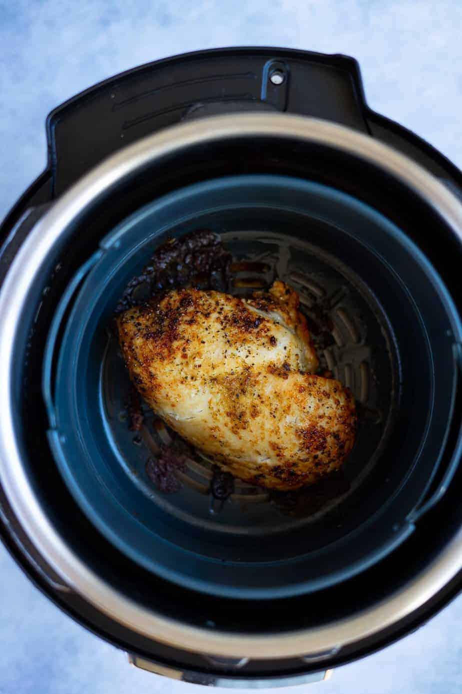cooked frozen chicken breast in the air fryer with a salt free seasoning and salt to taste inside the air fryer basket using the instant pot air fryer lid.