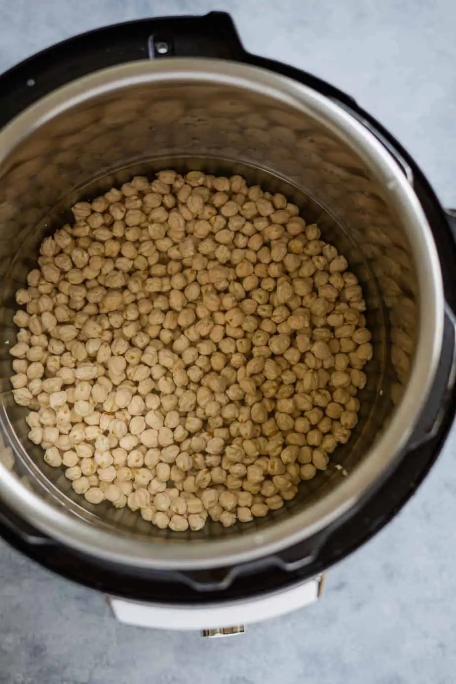 dried chickpeas with water inside the instant pot to pressure cook and make homemade hummus.