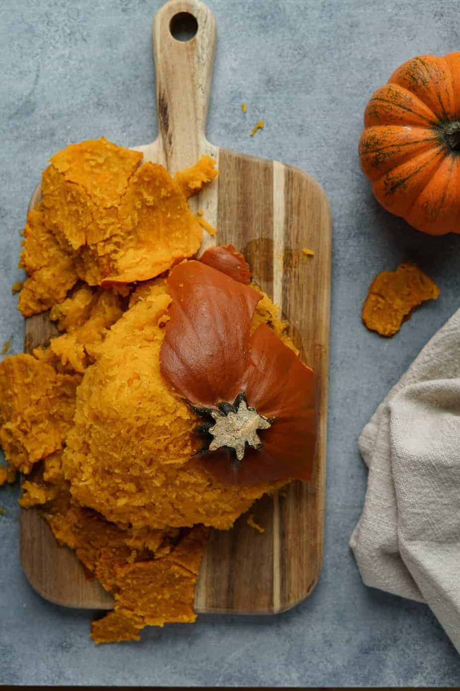 Remove the trivet and start peeling the pumpkin skin off on a cutting board.