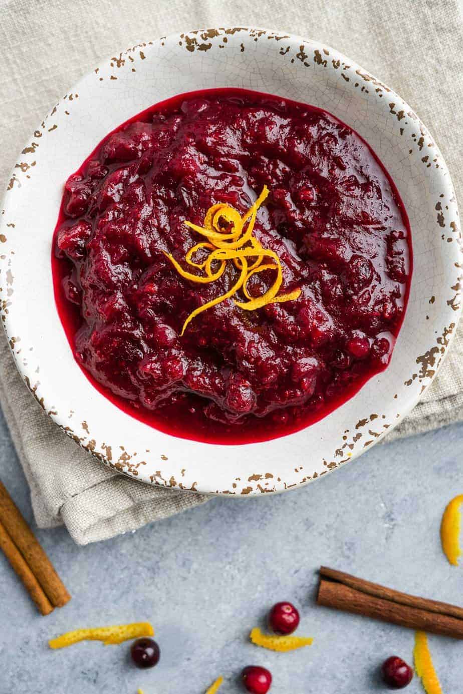 Instant pot cranberry sauce serve in a bowl and top with orange zest.