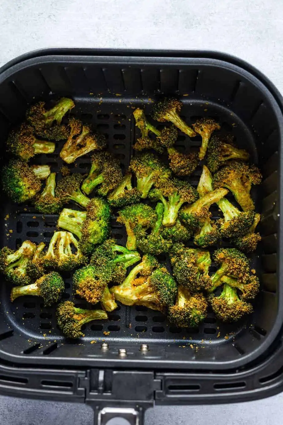 crispy air fryer broccoli inside the air fryer basket