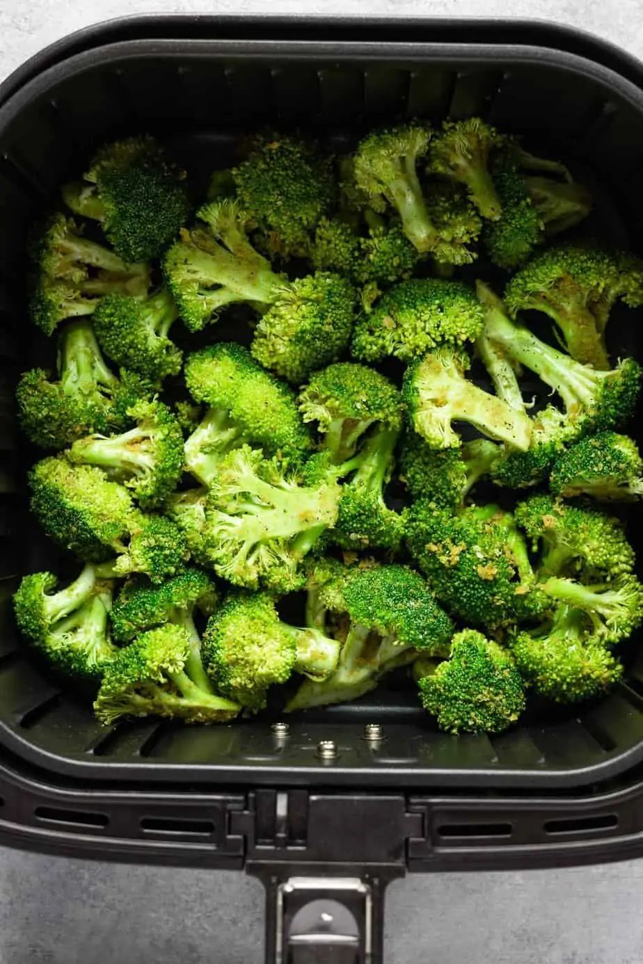arranged broccoli inside the air fryer basket