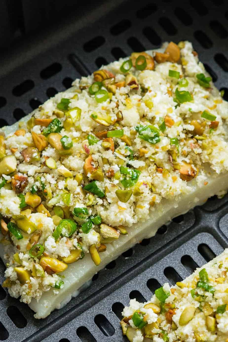 halibut fillets seasoned and cover with a pistachios crust.