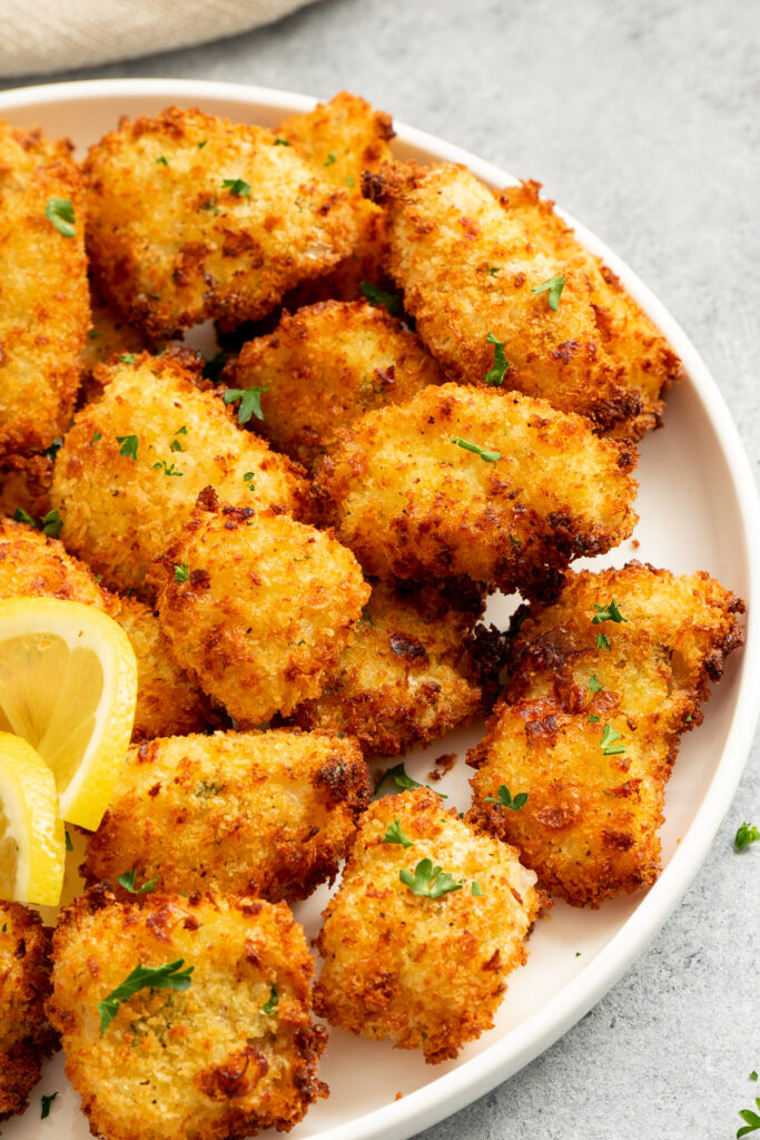 Serve with lemon wedges and dipping sauce crispy cod nuggets.