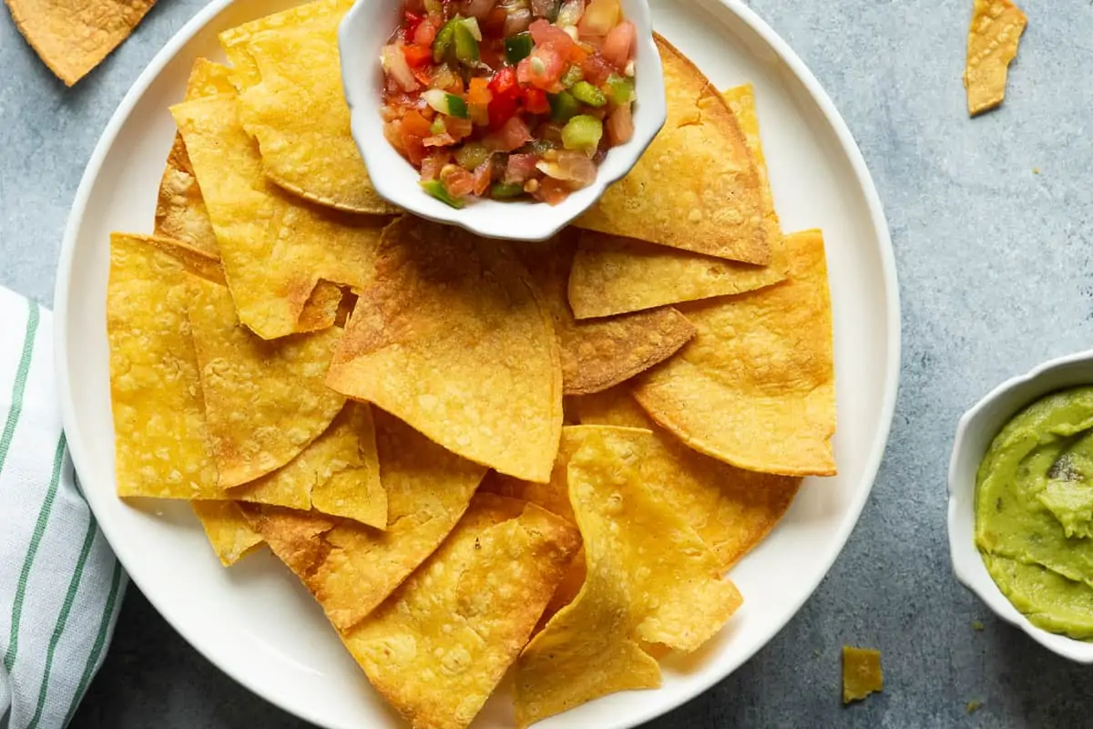 air fryer tortilla chips serve with salsa and guacamole.