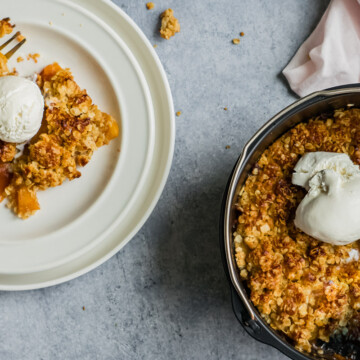 air fryer peach crisp with ice cream on top.