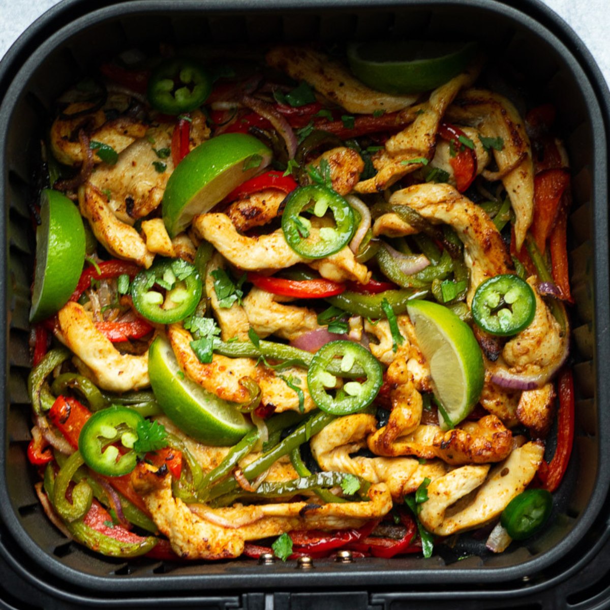 air fryer chicken fajitas in the basket.