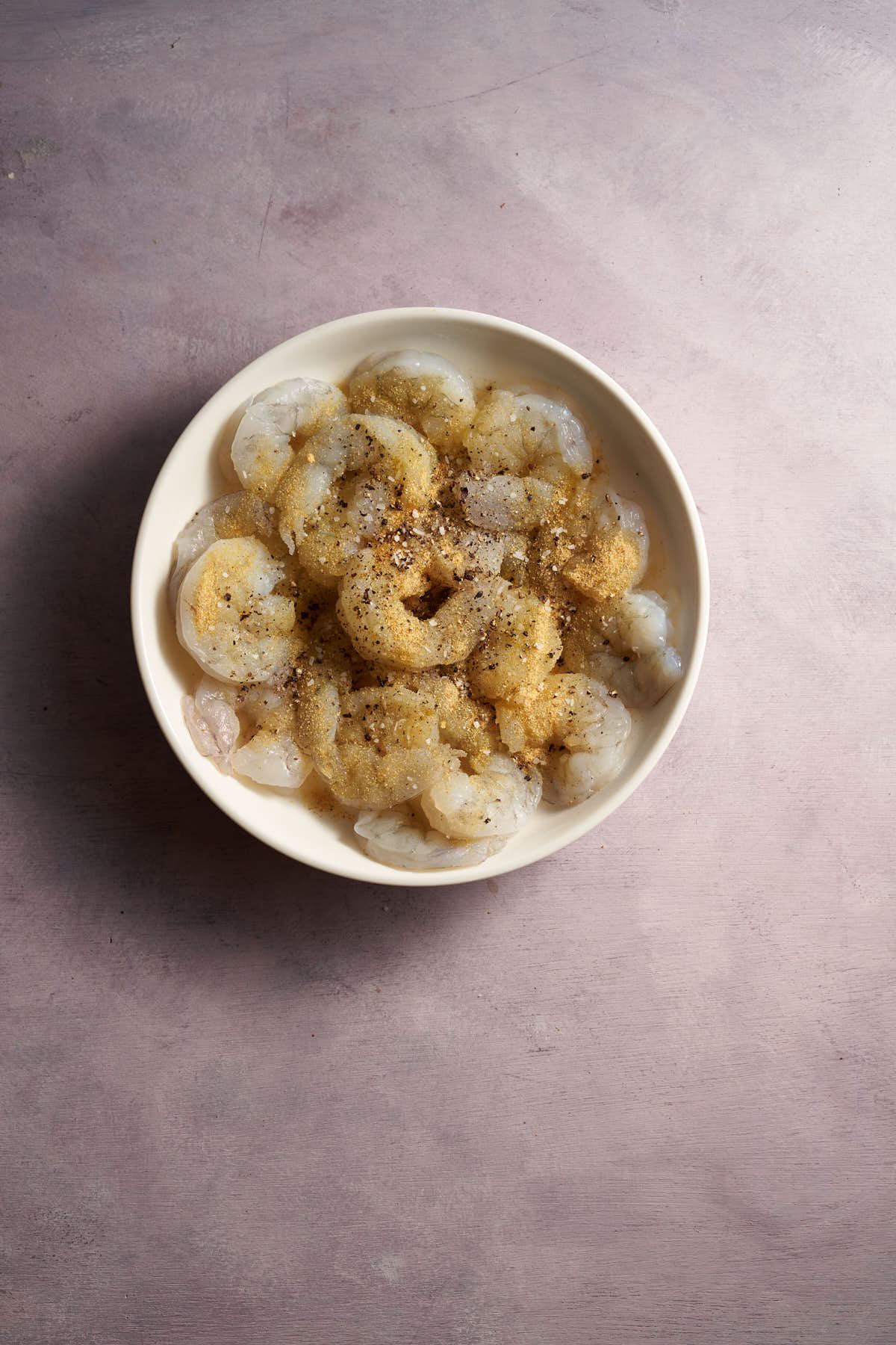 Large peeled and deveined raw shrimp ready to season.