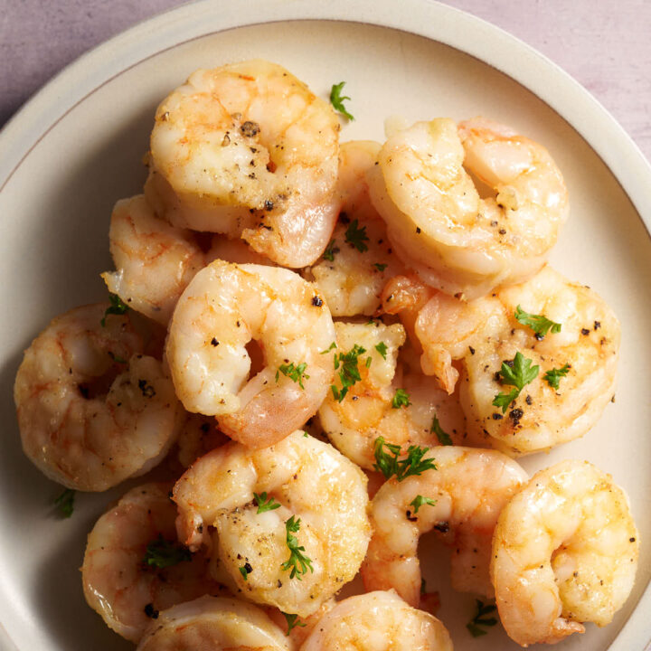 air fryer shrimp. on a plate garnish with fresh parsley.