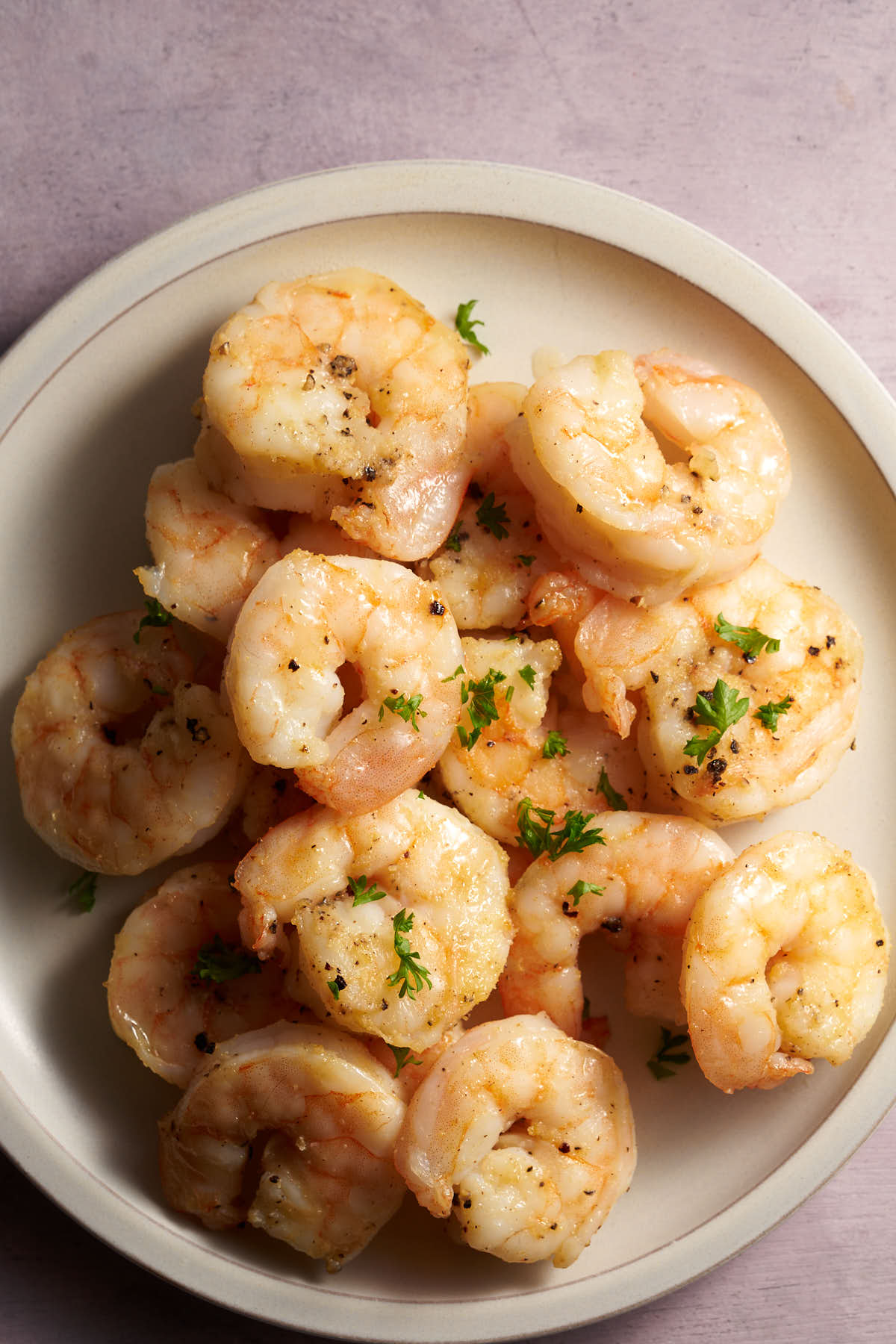 Air fryer shrimp seasoned with garlic powder, onion powder, salt, and pepper
