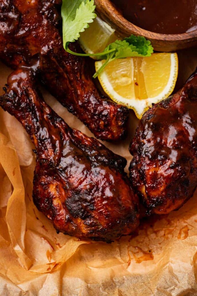 BBQ chicken legs air fryer serve with more bbq sauce for dipping.