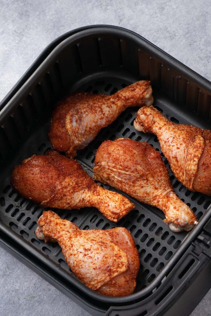 Drumstick in the air fryer before air frying.