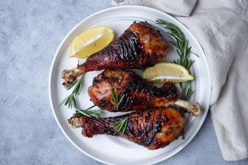 serve with lemon wedges and fresh rosemary on a plate.
