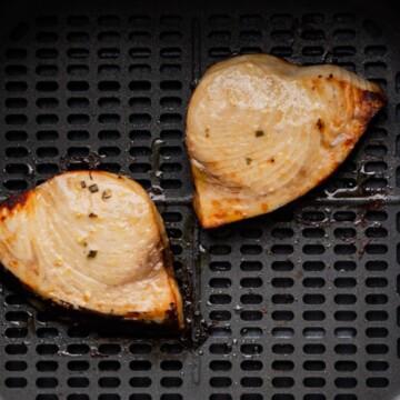 air fryer swordfish steak in the basket.