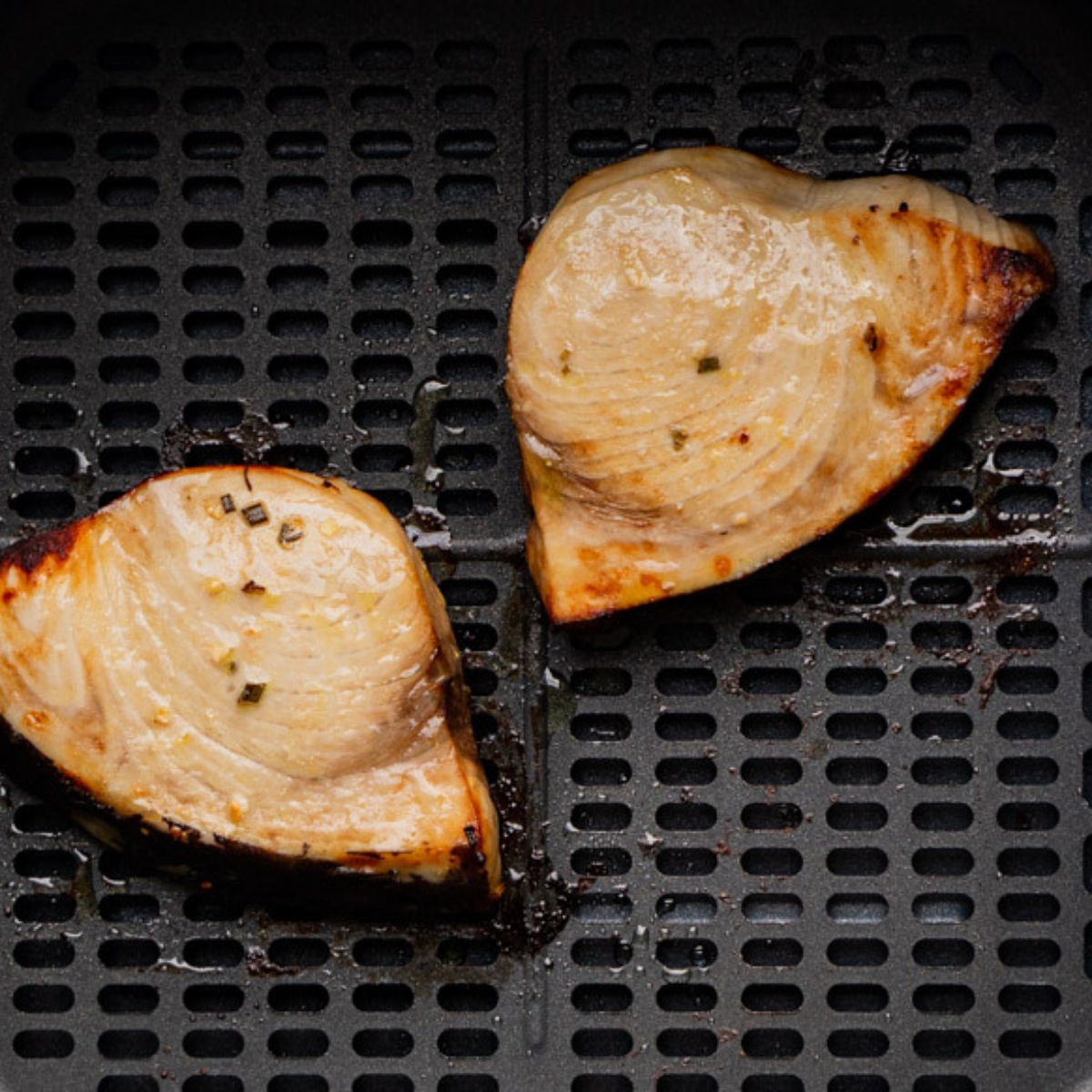 air fryer swordfish steak in the basket.
