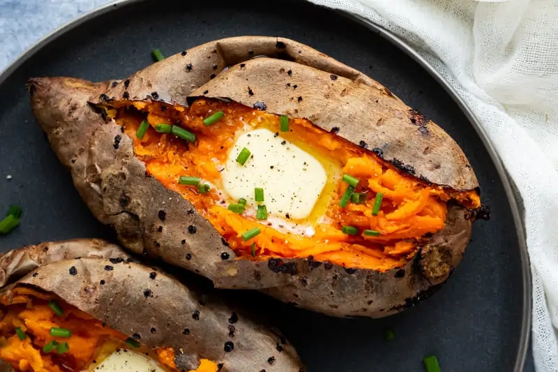 sweet potatoes serve on a plate and sprinkle with chives and top with butter