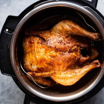 instant Pot air fryer lid Whole chicken inside the inner pot after cooking.