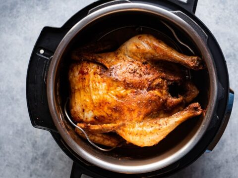 instant Pot air fryer lid Whole chicken inside the inner pot after cooking.