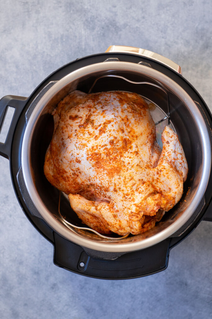 The seasoned chicken inside the inner pot before air frying with the lid.