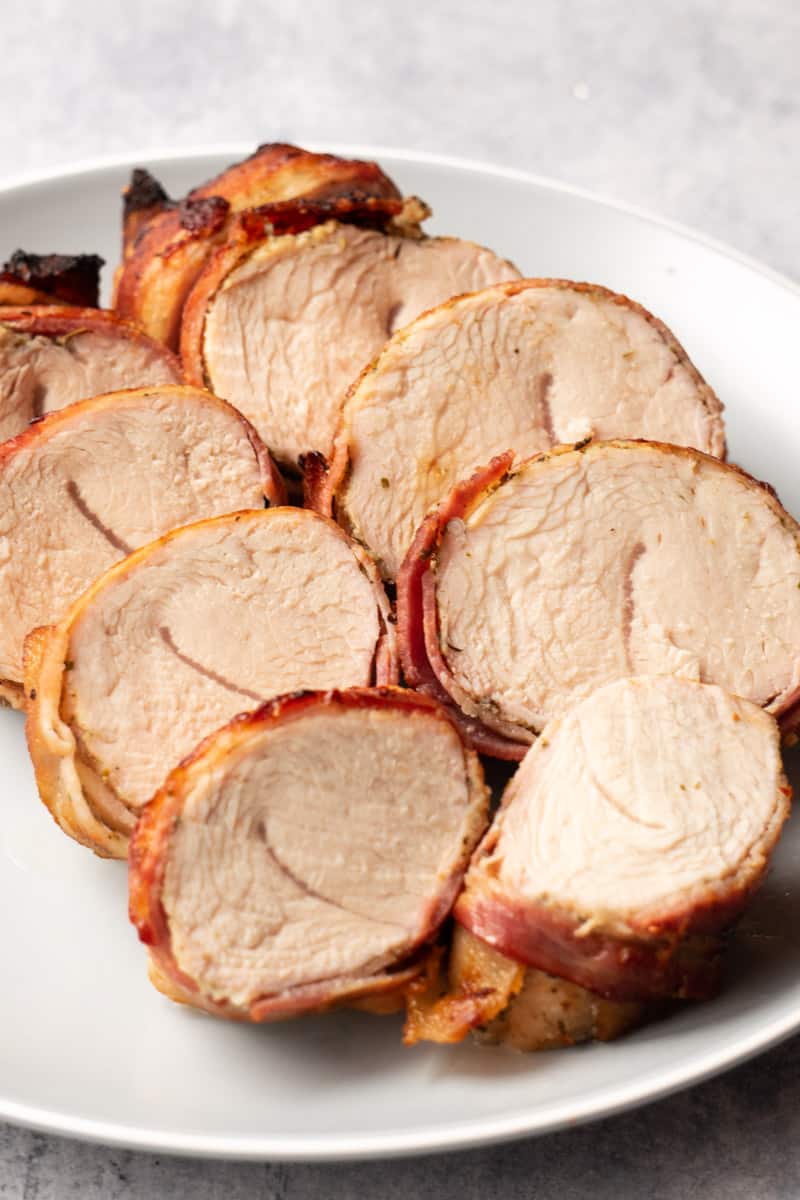 Air fryer bacon-wrapped turkey tenderloin sliced and plated.
