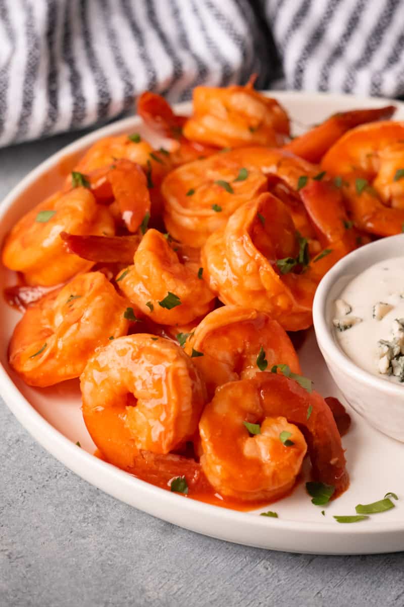 Juicy buffalo shrimp served with blue cheese dressing and sprinkled with fresh parsley.