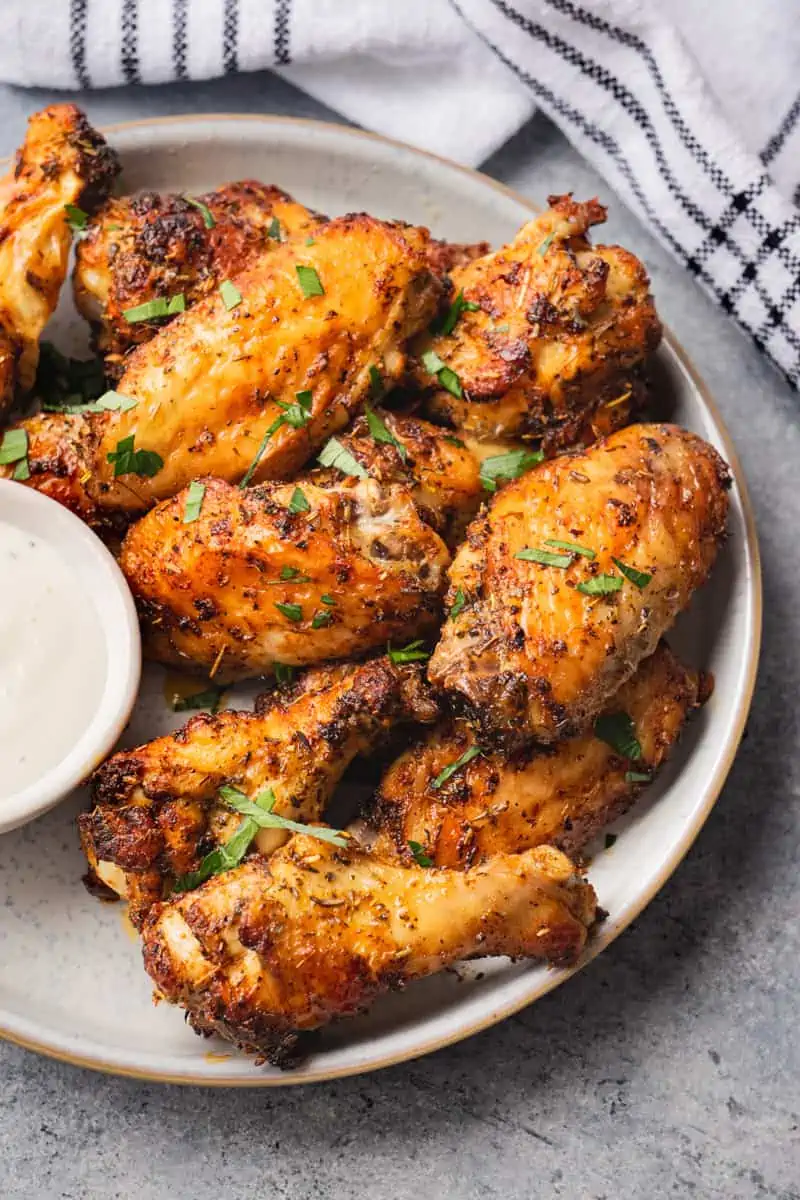 Homemade chicken wings served with dipping sauce.