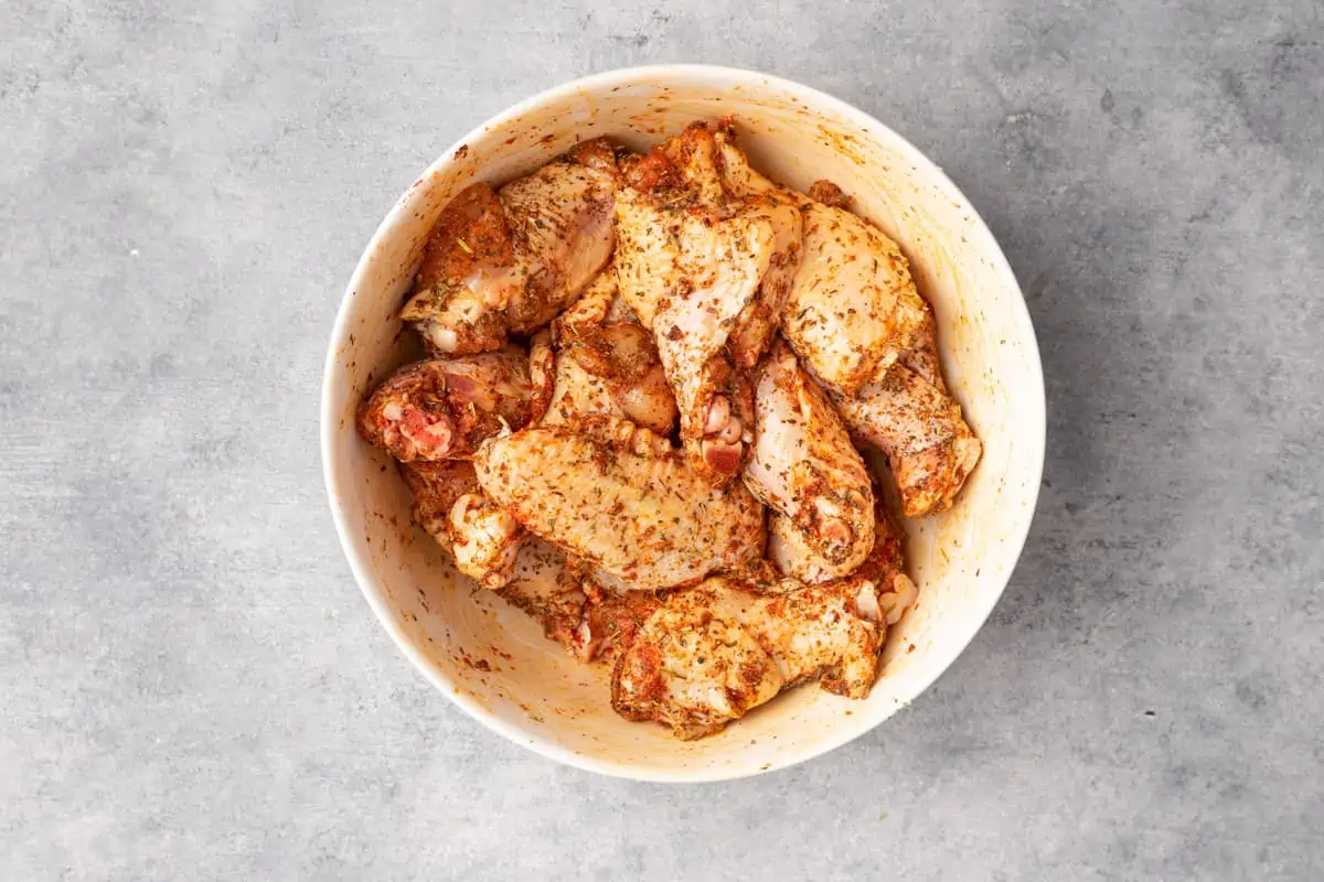In a bowl the seasoned chicken wings.
