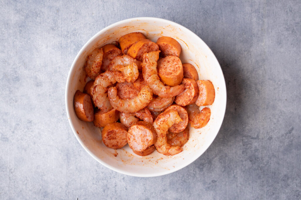 Seasoned sausage and shrimp in a bowl.