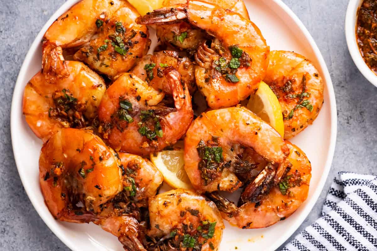 Air fryer shrimp with shell, serve with herbs sauce and fresh lemon slices.