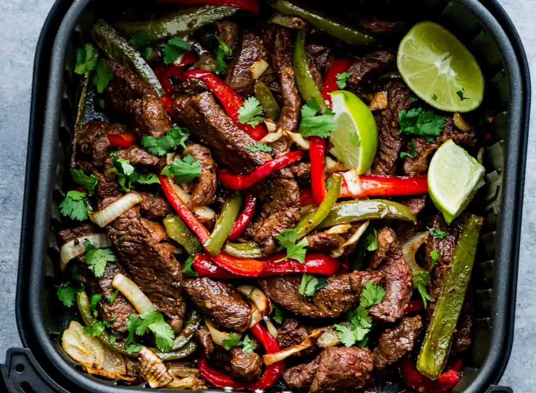 air fryer Beef fajitas and top with lime wedges and chopped fresh cilantro