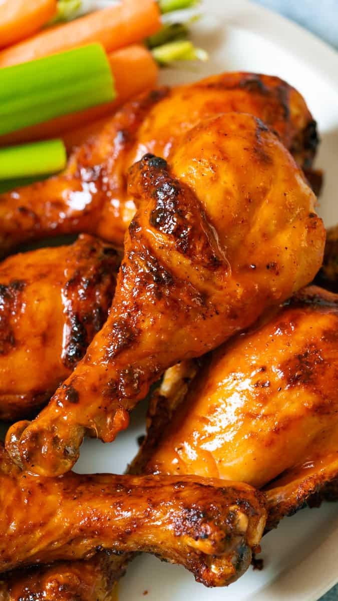 Buffalo chicken drumsticks with celery and ranch.