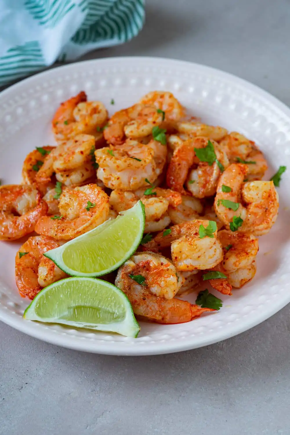 Air-fried tajin shrimp served with parsley and lime.