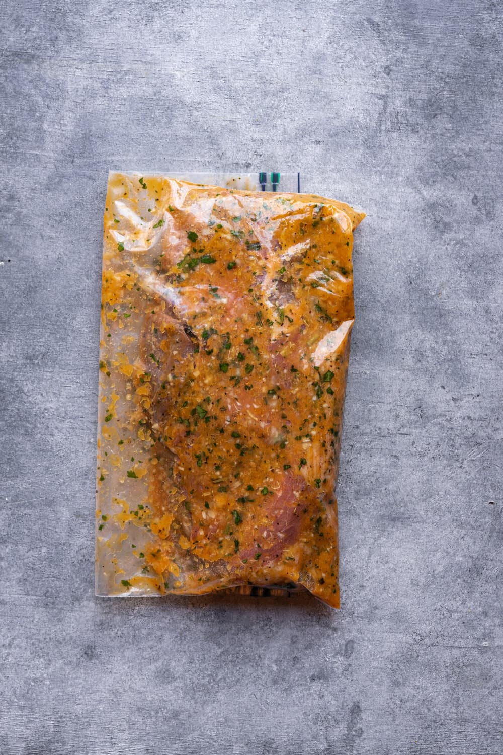Steak and marinade in a sealed ziploc bag.