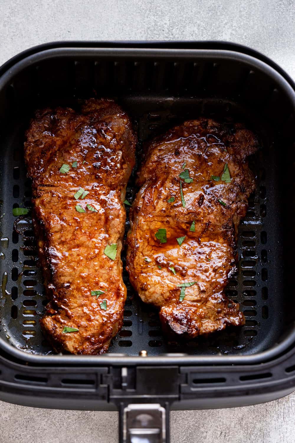 ny strip steak in the air fryer basket.