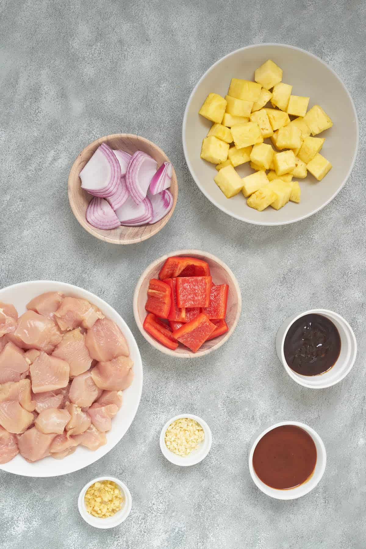 Ingredients to make chicken and pineapple kabobs.