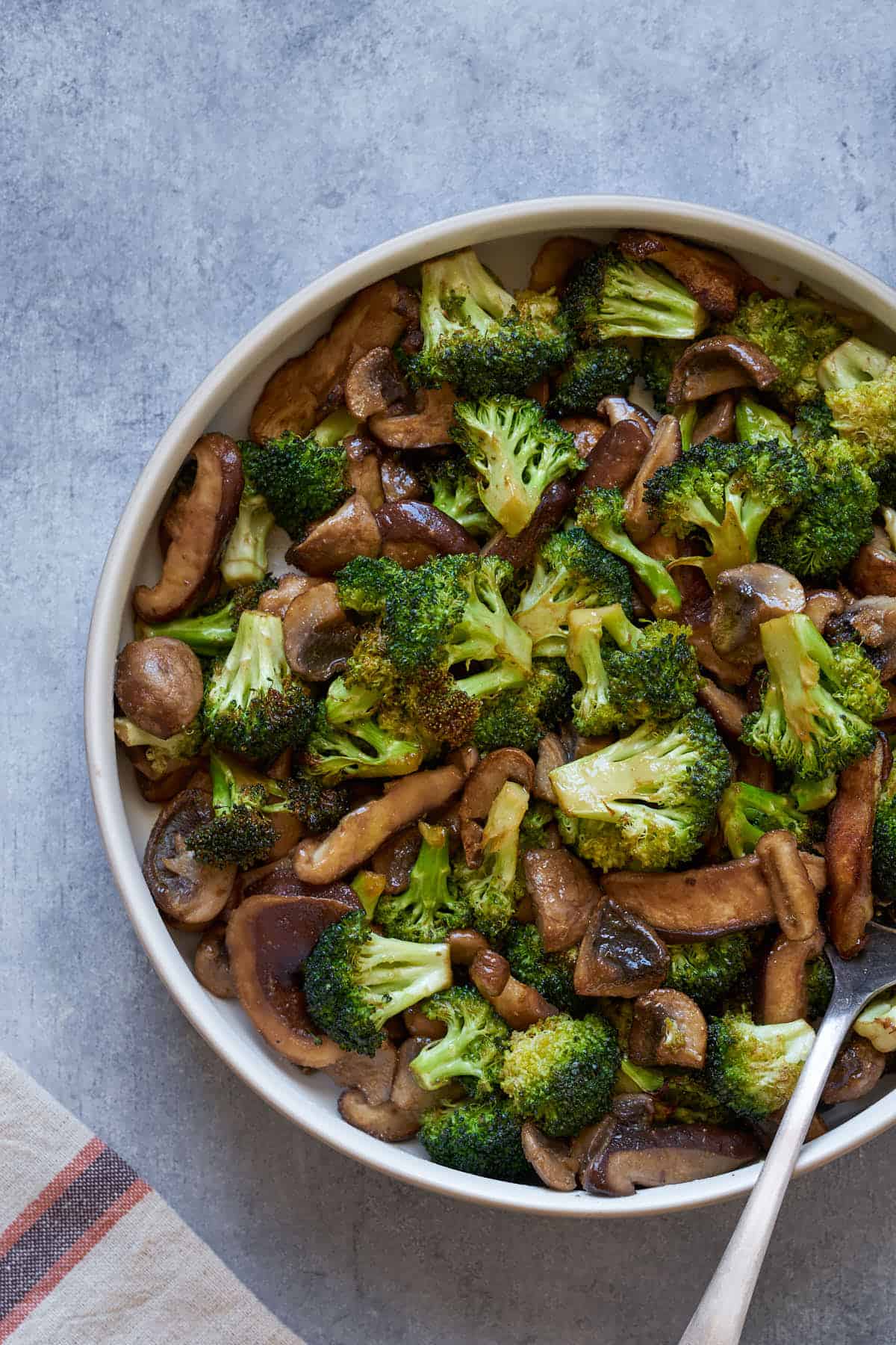 Air fryer broccoli and mushrooms in a bowl.