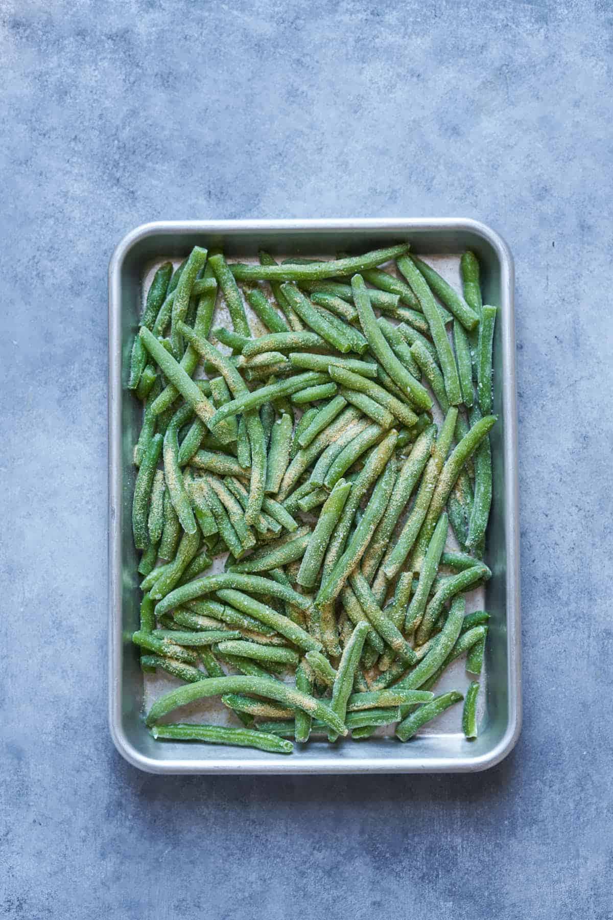 Frozen green beans with oil, garlic powder, and salt and pepper.