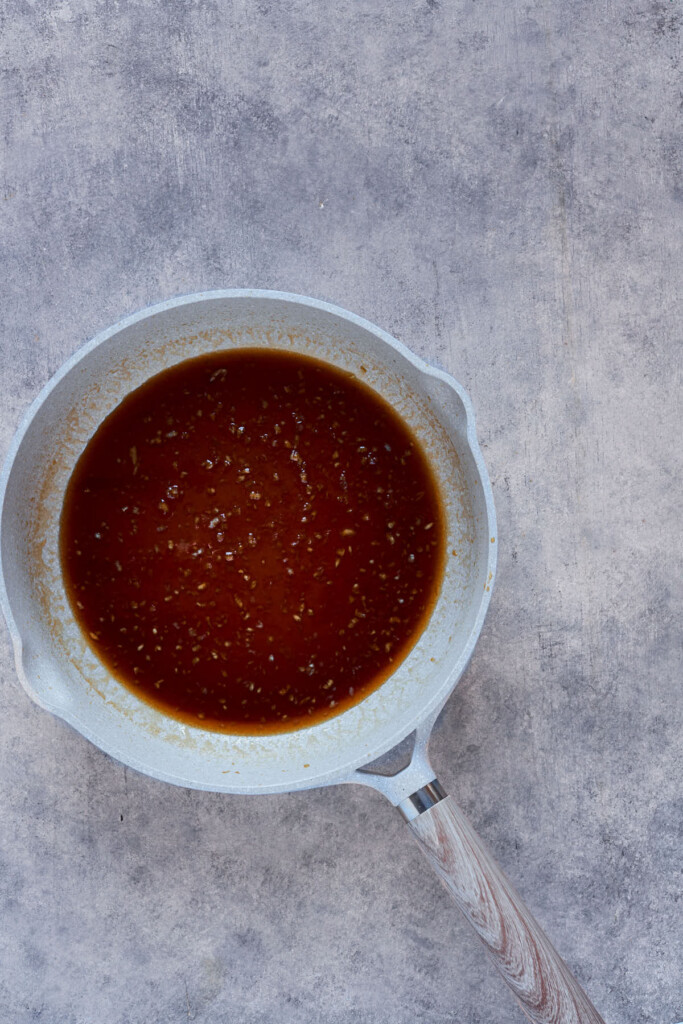 Ingredients to make honey garlic sauce in a saucepan.