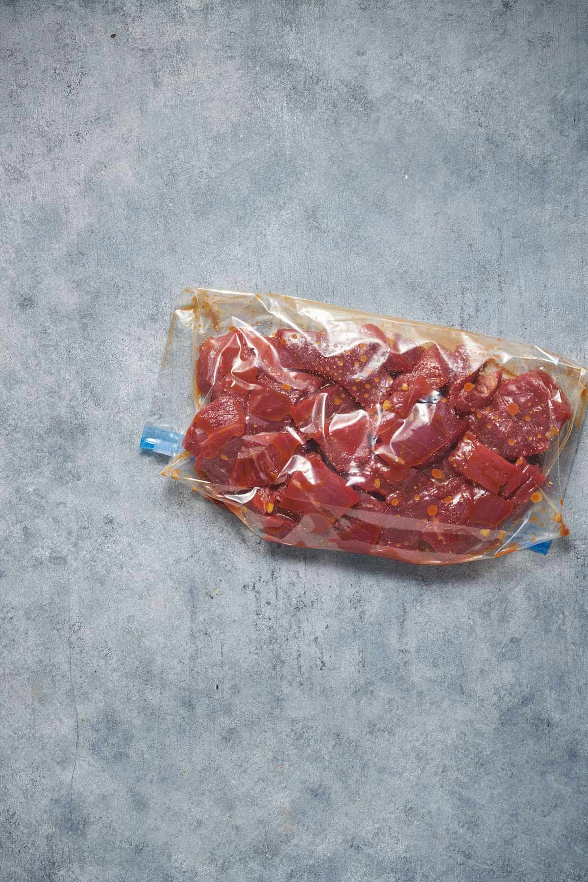 The meat with marinade in a ziplock bag.