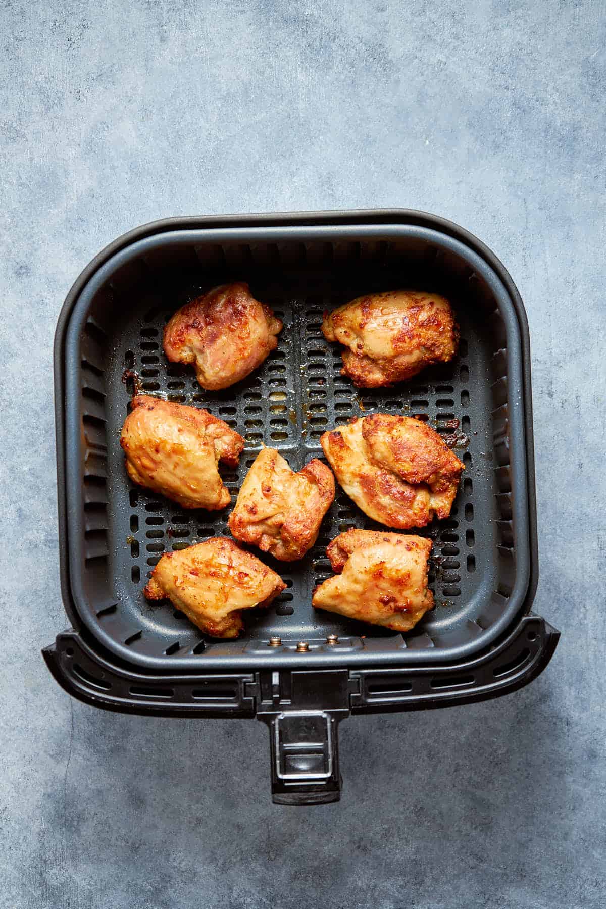 Cooked meat inside the air fryer basket