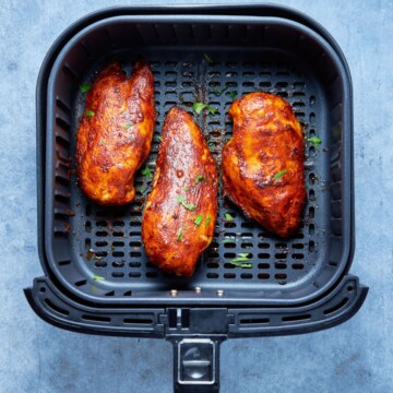 bbq chicken breast in the air fryer basket after cooking