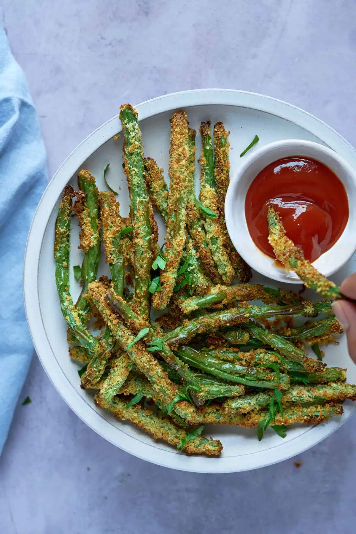 Crispy air fryer green beans fries served with dipping sauce.