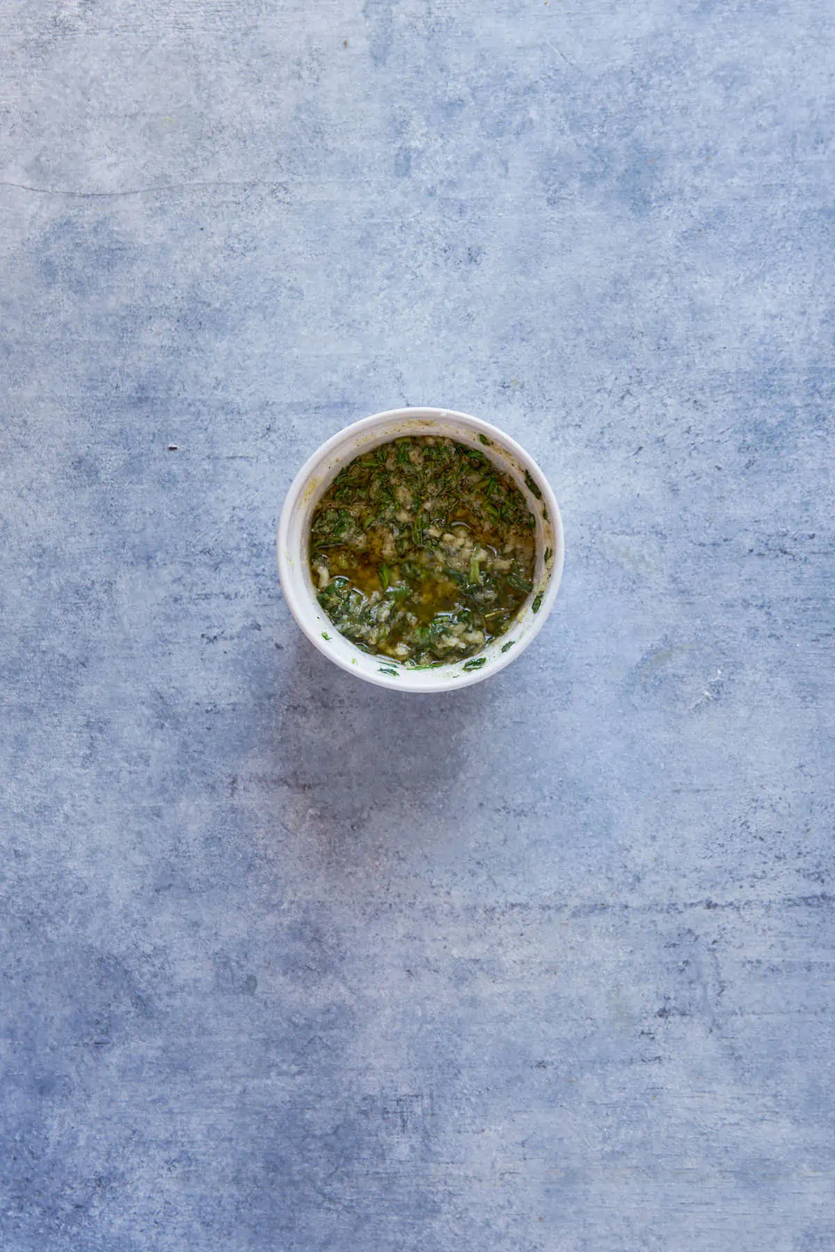 Mixing the herbs in a small bowl.